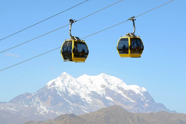 Bolivians use the yellow cable car line to make their way from El Alto, located at an altitude of 4,000 m above sea level, to the city centre of La Paz, Bolivia, 07 July 2015. Illimani, a local mountain of La Paz, is pictured in the background. Photo by: Georg Ismar/picture-alliance/dpa/AP Images